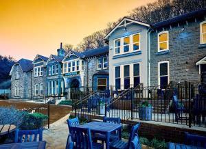 a house with a table and chairs in front of it at Craigside Manor in Llandudno