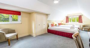 a bedroom with a large bed and two chairs at Best Western The Webbington Hotel & Spa in Loxton +80 photos