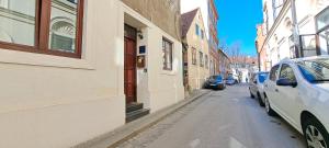 a street with cars parked on the side of a building at Tomcat in Zagreb +1 photo