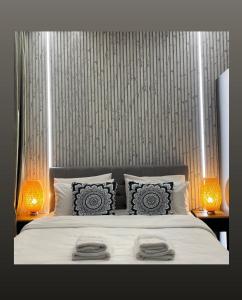 a bedroom with a white bed with two lamps at Arame Luxury Apartments in Athens