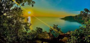 a view of a body of water with a sunset at Sweet Time Bungalows in Koh Rong Sanloem