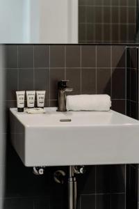 un lavabo blanc dans une salle de bain avec un miroir dans l'établissement Town Centre Cozy 2 Bed 1 Bath with Free Parking, à Belconnen 6 autres photos