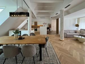 a dining room and living room with a table and chairs at Apartma Tyrseva in Maribor