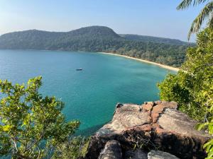 a view of a beach with a boat in the water at Sweet Time Bungalows in Koh Rong Sanloem