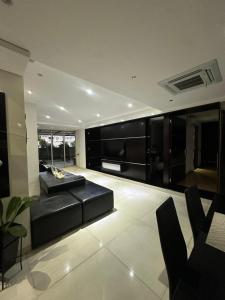 a living room with a couch and a bed at Luxury Apartment Hot Tub in South Cali in Cali