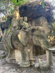 a statue of an elephant with people sitting on it at Sweet Time Bungalows in Koh Rong Sanloem