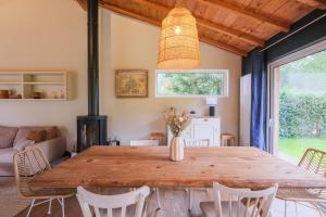 a dining room with a large wooden table and chairs at Villa Madonne - Piscine - Plage in Lège-Cap-Ferret