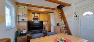 a kitchen with a dining room table with a television at Haus Morgensonne im Steyrtal in Obergrünburg