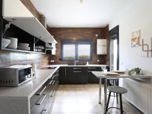 a kitchen with a counter and a table in it at Villa Incognito With Pool - Perfect Hospitality in Thérmi