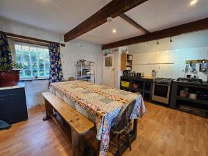 a kitchen with a table in the middle of a room at Bunkhouse Northumberland in Preston