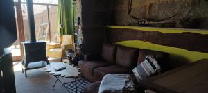 a living room with a couch and a wood stove at O Poleiro do Xurés in Maus de Salas