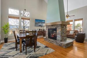 a living room with a table and a fireplace at Timber Court in Granby