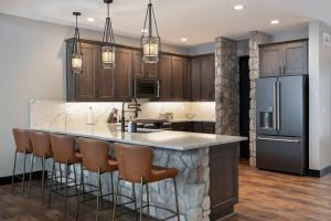 a kitchen with a large island with bar stools at Lone Eagle 765 in Granby