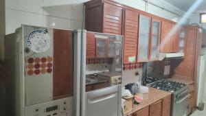 a kitchen with wooden cabinets and stainless steel appliances at نهر النيل in Cairo