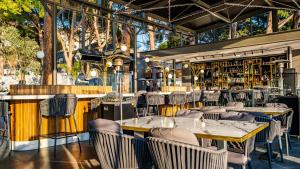 a restaurant with tables and chairs and a bar at Unique Life Style Hotel in Kuşadası