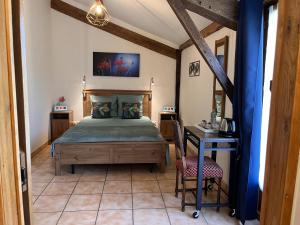 a bedroom with a bed and a table and chairs at Maison M in Surin