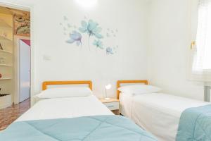A bed or beds in a room at Appartamento Milly