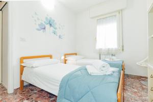 A bed or beds in a room at Appartamento Milly