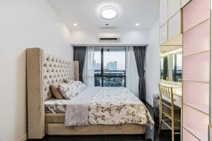 a bedroom with a bed and a large window at Makati City Centre Condo in Manila +78 photos