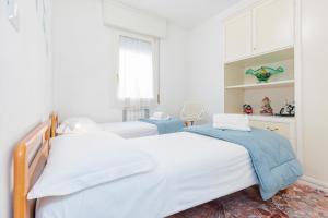 A bed or beds in a room at Appartamento Milly