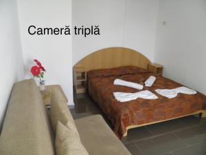 Postel nebo postele na pokoji v ubytování Complex Gec Histria Mamaia