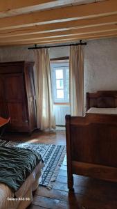 a bedroom with a bed and a window at Les volets bleus in Les Angles