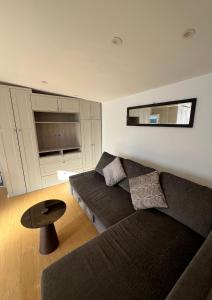 a living room with a couch and a table at Modern Studio in Greenford, Free WiFi, Parking & Streaming Services in Ealing
