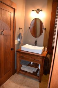 a bathroom with a sink and a mirror at Elkstone Panoramic Views from Blowing Rock to Grandfather in Blowing Rock +49 photos