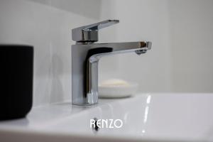 a bathroom sink with a faucet on a counter at Homely 2-bed Apartment in Newark on Trent by Renzo, Free Parking, Brilliant Location! in Newark upon Trent +17 photos
