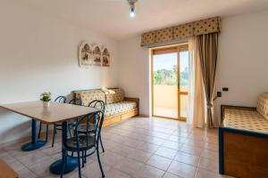 a room with a table and chairs and a window at Centro Turistico Akiris in Nova Siri Marina