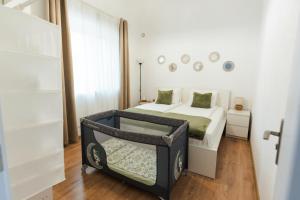 a white bedroom with a bed and a mirror at Apartment Velik in Sandanski