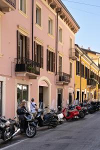 a row of motorcycles parked in front of a building at Ponte Nuovo BB in Verona