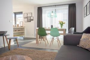 a living room with a couch and a table and chairs at Südstrandquartier - Ferienwohnung Cor in Ostseebad Sellin +26 photos