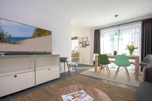 a living room with a view of the ocean at Südstrandquartier - Ferienwohnung Cor in Ostseebad Sellin