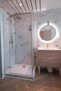 a bathroom with a shower and a sink at Hôtel Castel Jeanson in Ay