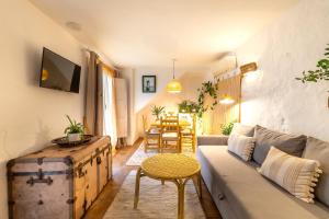 a living room with a couch and a table at Romantic Ronda garden cottage in Ronda