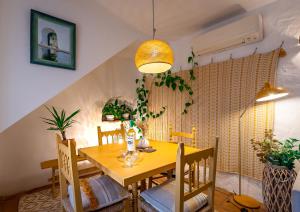 a dining room with a wooden table and chairs at Romantic Ronda garden cottage in Ronda
