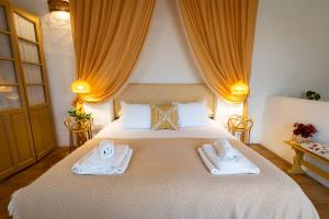 a bedroom with a bed with two towels on it at Romantic Ronda garden cottage in Ronda +33 photos