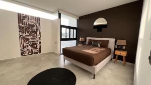 a bedroom with a bed and a large window at Tu Villa Adosada Lujo con Playa y Golf in Akumal