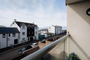 a view of a street from a balcony of a building at MD Stays in Portstewart