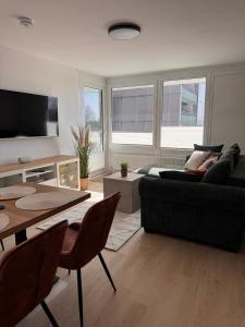 a living room with a couch and a table at Fewo Strandbrise in Eckernförde