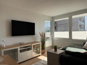 a living room with a flat screen tv on a wall at Fewo Strandbrise in Eckernförde