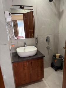 a bathroom with a sink and a mirror at Cookies Home in Dehradun +5 photos