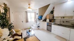 a kitchen with white cabinets and a table in a room at Isha's Place Self Check-In 2BR Netflix WiFi Camella Homes Villakananga in Butuan