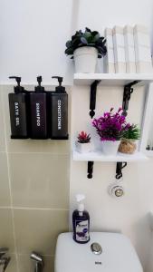 a bathroom with a toilet and a shelf with books at Isha's Place Self Check-In 2BR Netflix WiFi Camella Homes Villakananga in Butuan +23 photos