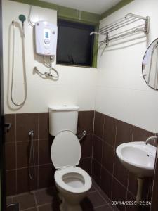 a bathroom with a toilet and a sink at D GAYA HOTEL Cameron Highlands in Tanah Rata