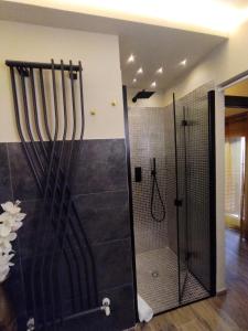 a bathroom with a shower with a glass door at La Signoria Relais in Ferrara
