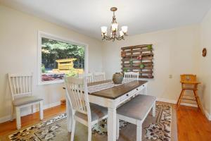 a dining room with a table and chairs and a window at Mountain Retreat Stunning Views Hot Tub Fire Pit in Mehoopany +23 photos