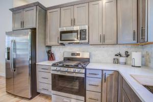 a kitchen with a stove and a microwave at Fox Den - Modern Mountain Home in Florissant