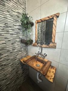 a bathroom with a wooden sink and a mirror at Marta's apartment in Shabla